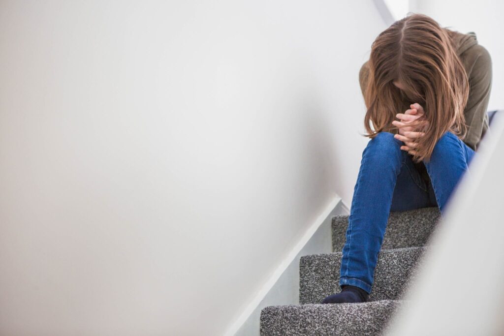 Woman sitting depressed on stairs