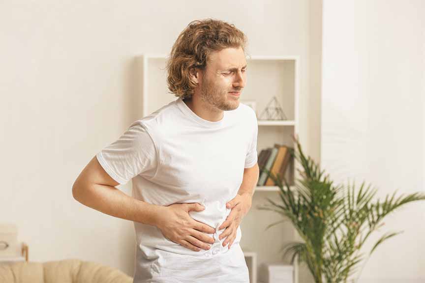 Man holding stomach in pain