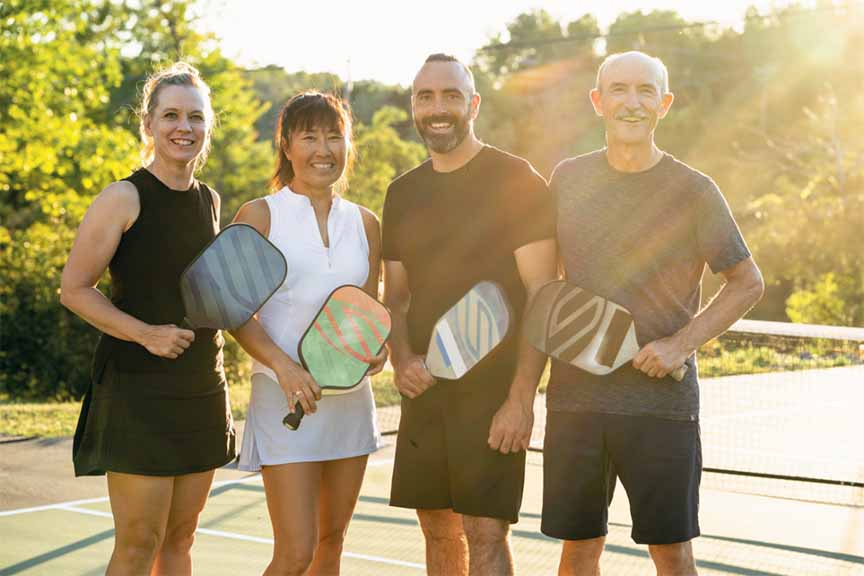 2 Couples playing pickleball