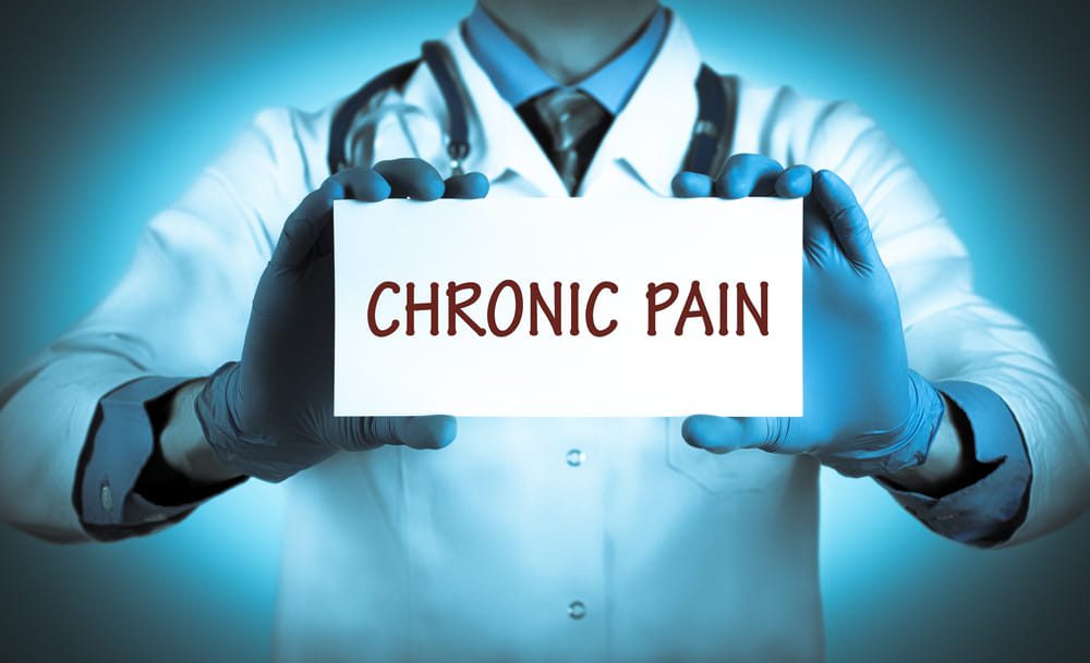doctor holding chronic pain card